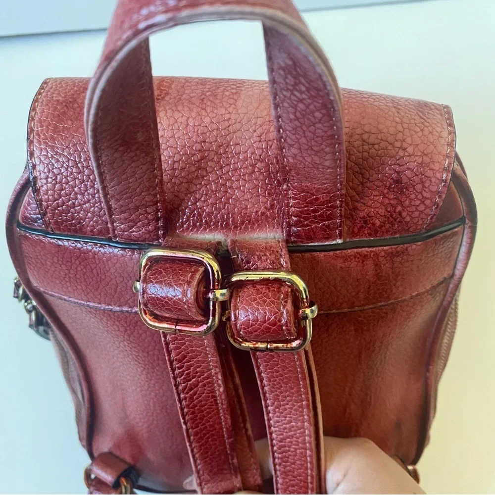 Distressed Circle Backpack With Red Flower lock Accent